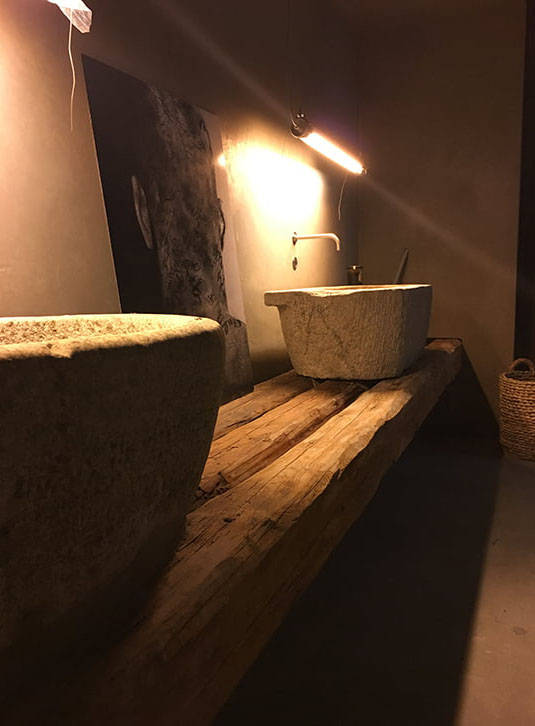 Close-up of a washbasin countertop made from reclaimed oak beams at the GATS restaurant